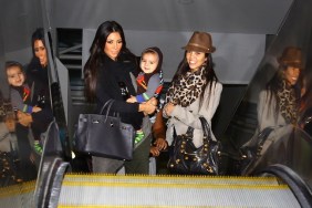 Kourtney Kardashian, Kim Kardashian, animal print scarf, brown hat, black tote bags, black sweater, airport